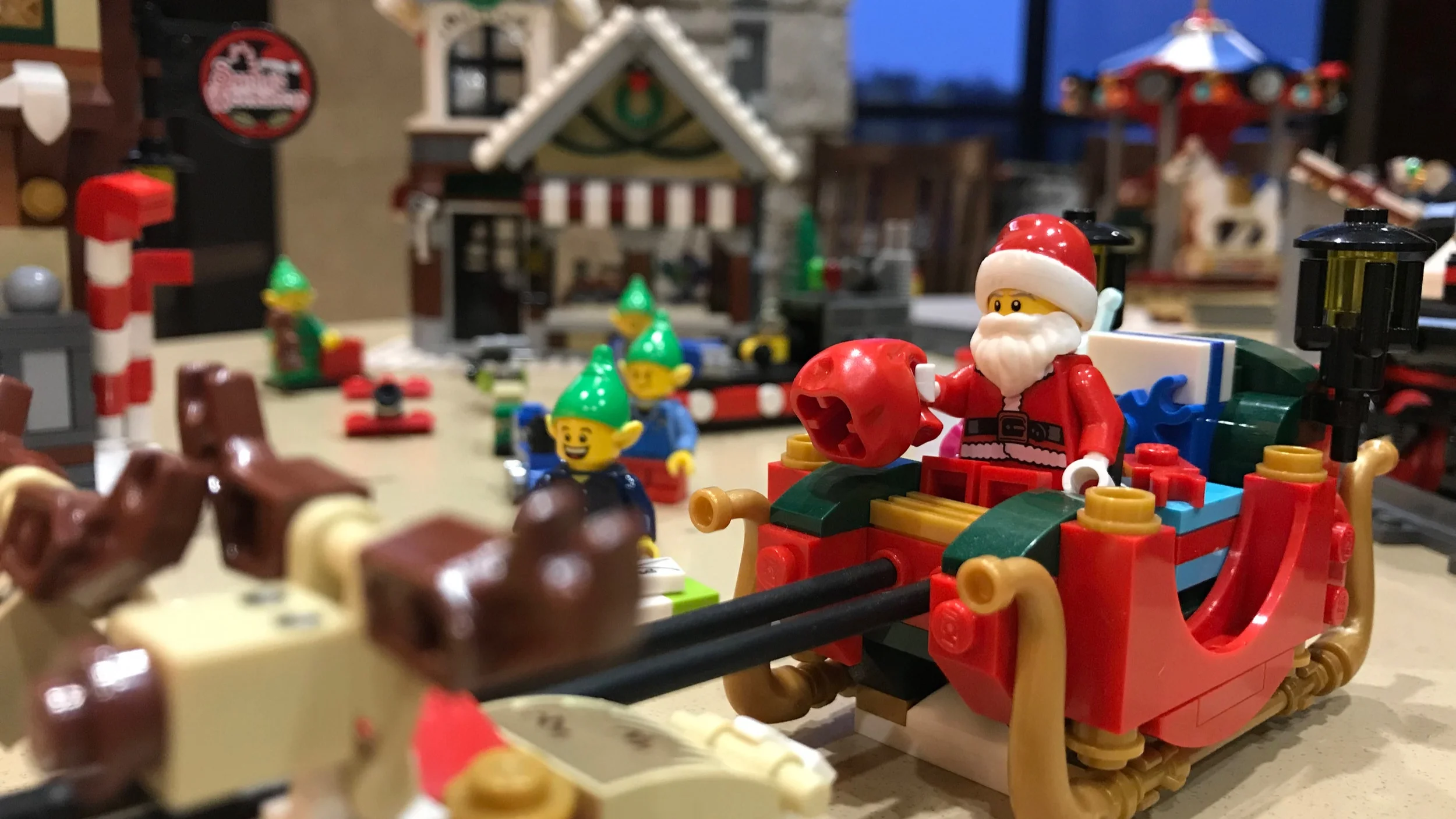 LEGO Winter Village scene featuring prominently Santa in his red sleigh.